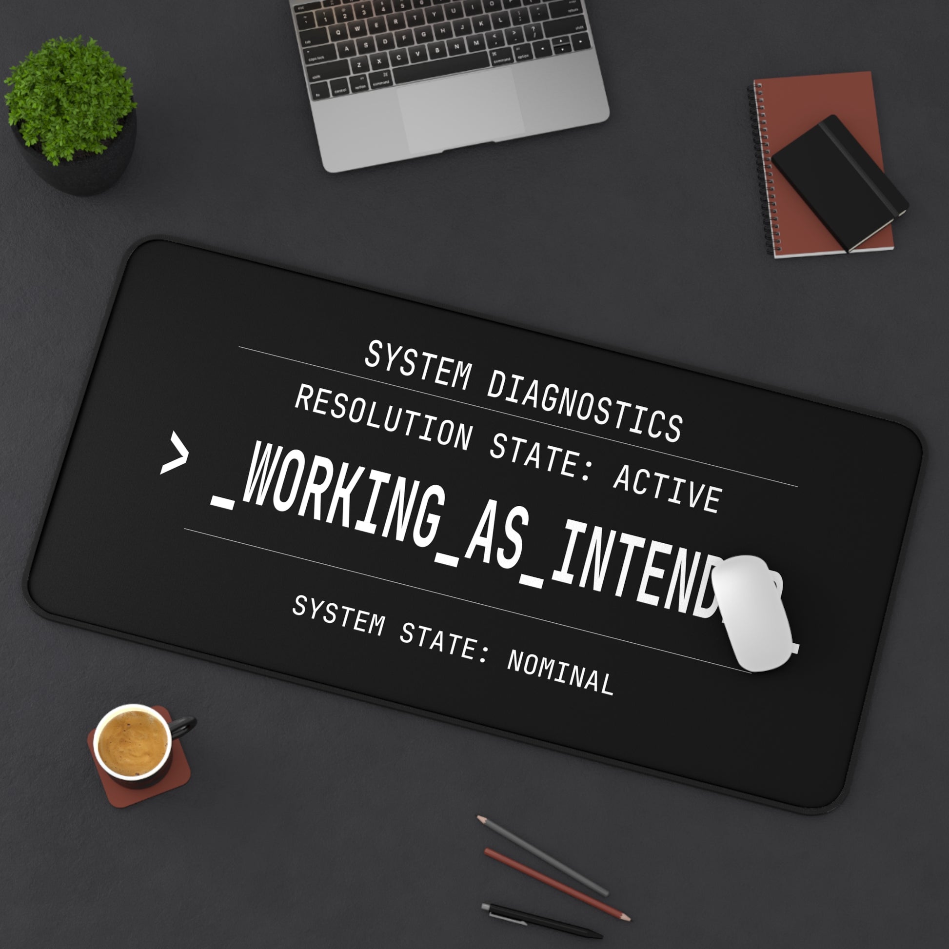 Black desk mat with white text on a dark surface with office items.
